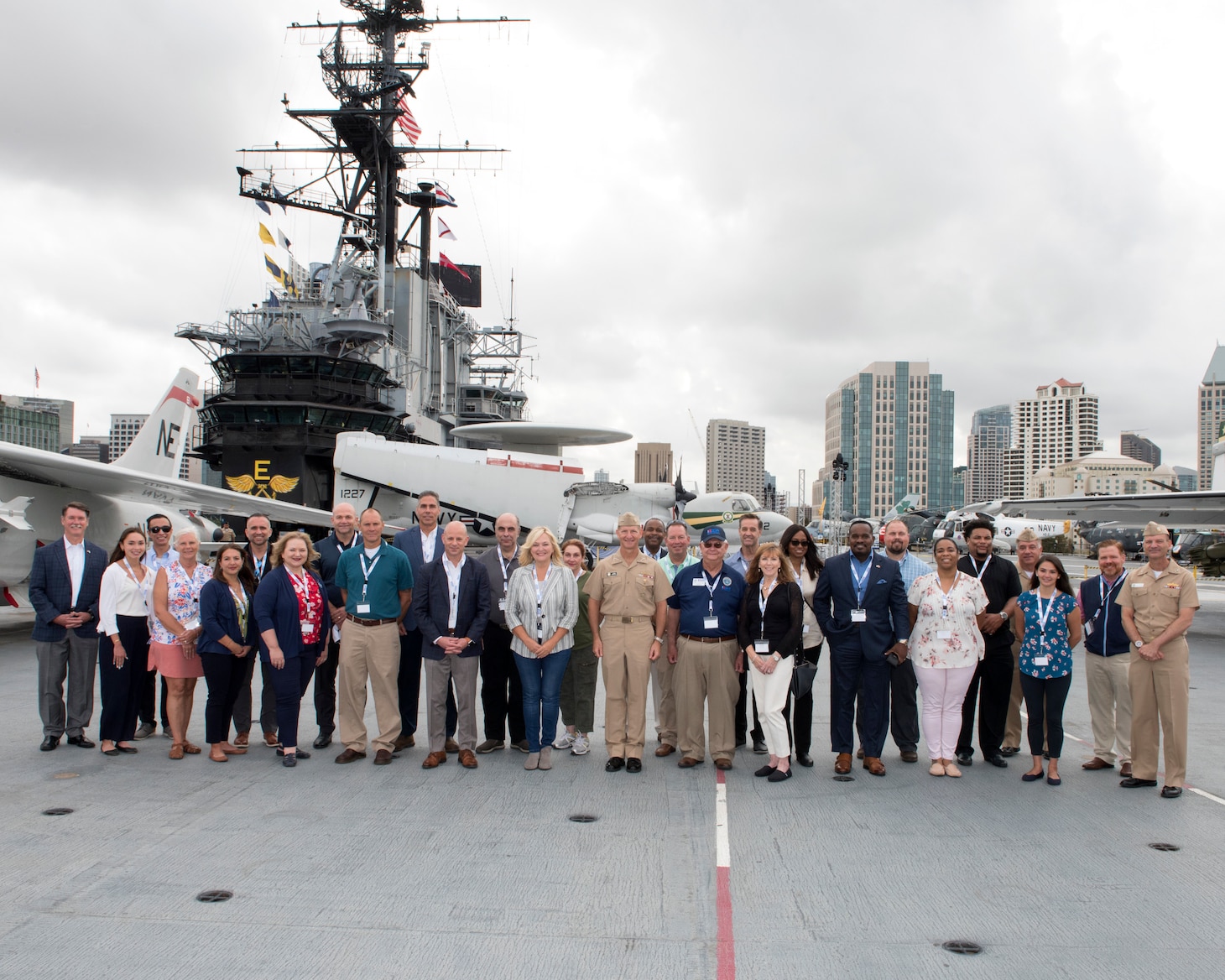 Chief of Navy Reserve Vice Adm. John Mustin, Commander, Navy Reserve Force and Rear Adm. John Schommer pose for a group photo with employer’s, aboard USS Midway Museum during a Navy Employer Recognition Event (NERE) in San Diego, August 20, 2021. Selected employers were nominated by their Navy Reserve employees for supporting their service and especially mobilization for the nation’s response to the COVID-19 pandemic, and invited to attend the one-day event that includes a tour of Midway, a static display of aircraft at Fleet Logistics Support Squadron (VR) 57, an equipment display by Maritime Expeditionary Security Squadron 1 and SEAL Team 17. The Navy Reserve mobilized 2,875 service members in 2020 under the presidential authorization for DoD’s support to the nation’s pandemic.