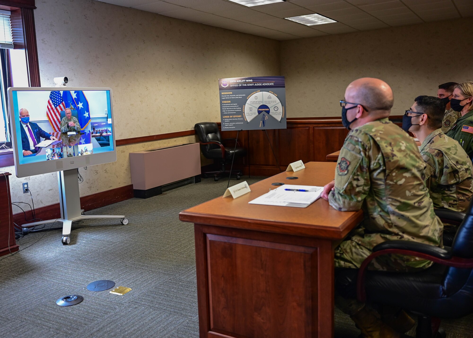 A group of people view a teleconference