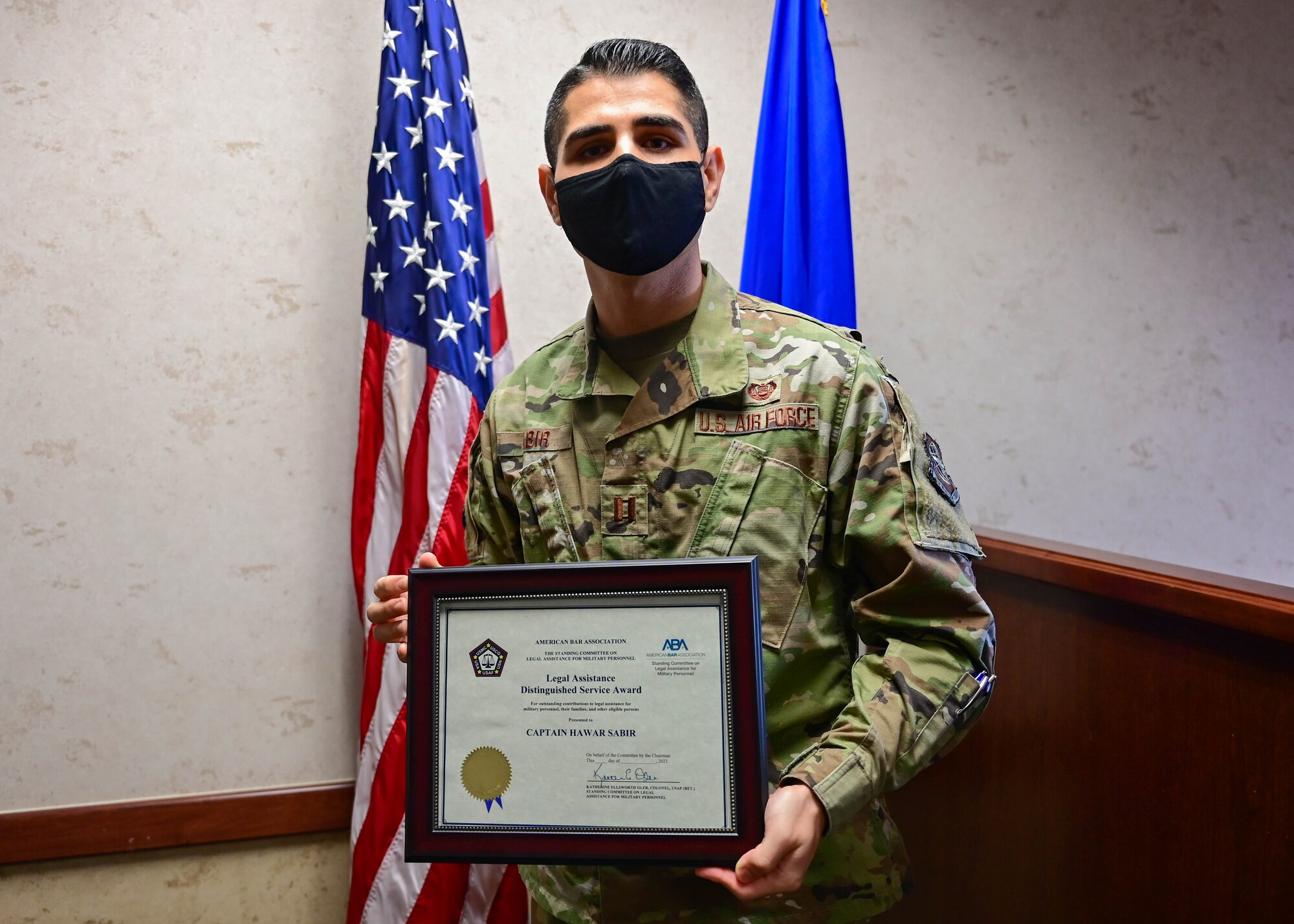 A man holds up an award