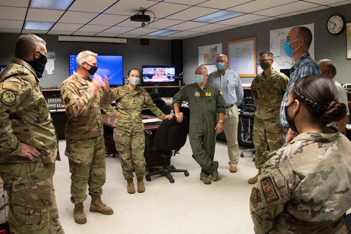 Emergency management leaders from Altus Air Force Base (AFB) and the city of Altus discuss the resources they can provide each other, as well as their reaction plans during different emergencies, while at the City of Altus emergency operations center, Aug. 18, 2021. The emergency management leaders from Altus AFB prepare the installation for response to major accidents, natural disasters and terrorist use of weapons of mass destruction. (U.S. Air Force photo by Airman 1st Class Trenton Jancze)