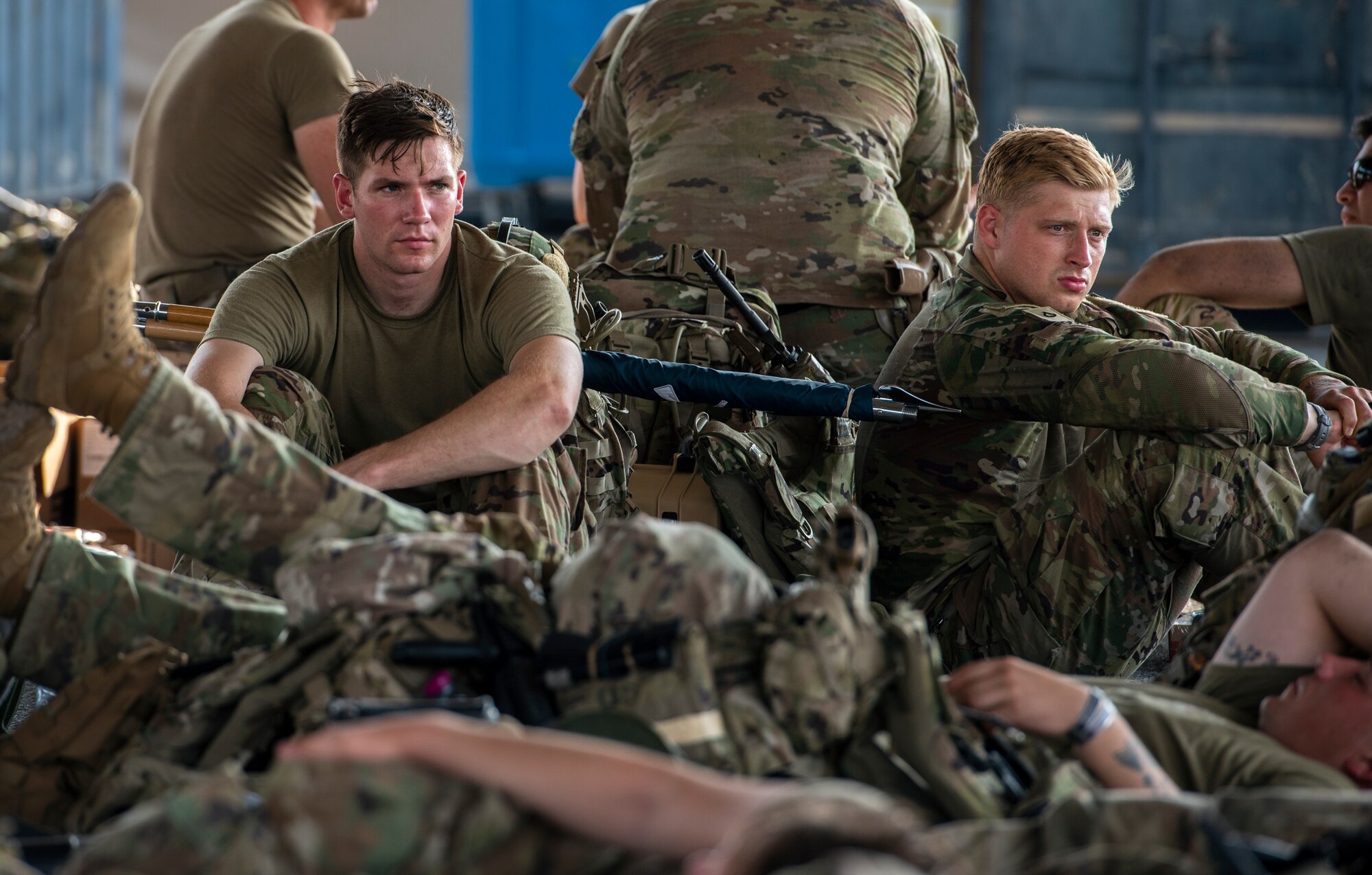 Service members rest and wait at Personnel Support for Contingency Operations on their way to Afghanistan Aug. 18, 2021, at an undisclosed location in Southwest Asia.