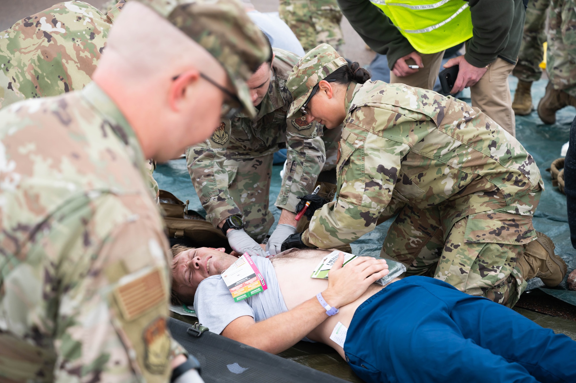 Airman 1st Class Michael Butterfill, center, 341st Civil Engineer Squadron horizontal construction technician, simulates being injured during an exercise Aug. 20, 2021, at Malmstrom Air Force Base, Mont.