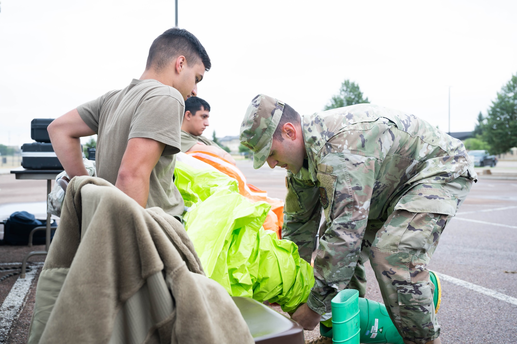 Capt. Daniel Wilkinson, right, 341st Operational Medical Readiness Squadron bioenvironmental engineering flight commander, helps Airman 1st Class Dylan Baggett, left, 341st OMRS bioenvironmental engineer apprentice, don a Level A fully encapsulating suit during a medical readiness exercise Aug. 20, 2021, at Malmstrom Air Force Base, Mont.