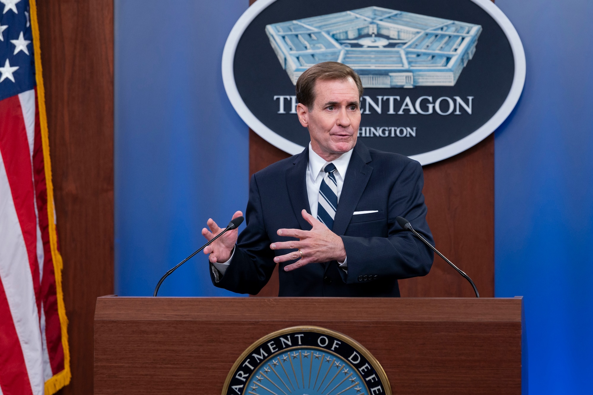 A man stands at a lectern. A sign behind him indicates that he is at the Pentagon.