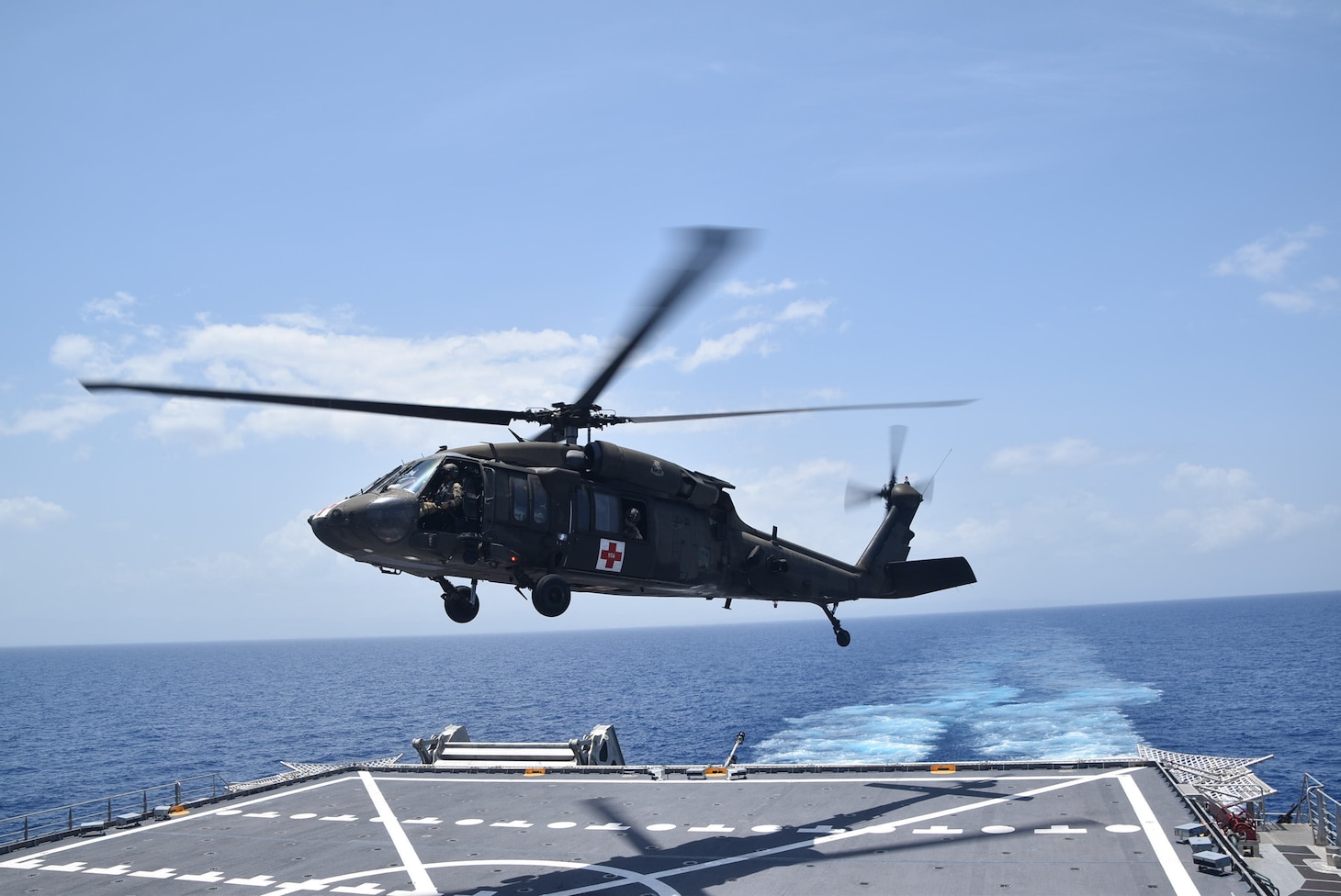 A U.S. Army UH-60 Blackhawk helicopter takes off from the Spearhead-class expeditionary fast transport ship USNS Burlington (T-EPF 10) after refueling, Aug. 21, 2021.