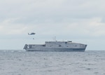 An MH-60R Seahawk helicopter, assigned “Easyriders” of Helicopter Maritime Strike Squadron (HSM) 37 delivers cargo to the Spearhead-class expeditionary fast transport USNS Burlington (T-EPF-10) Dec. 10, 2020.