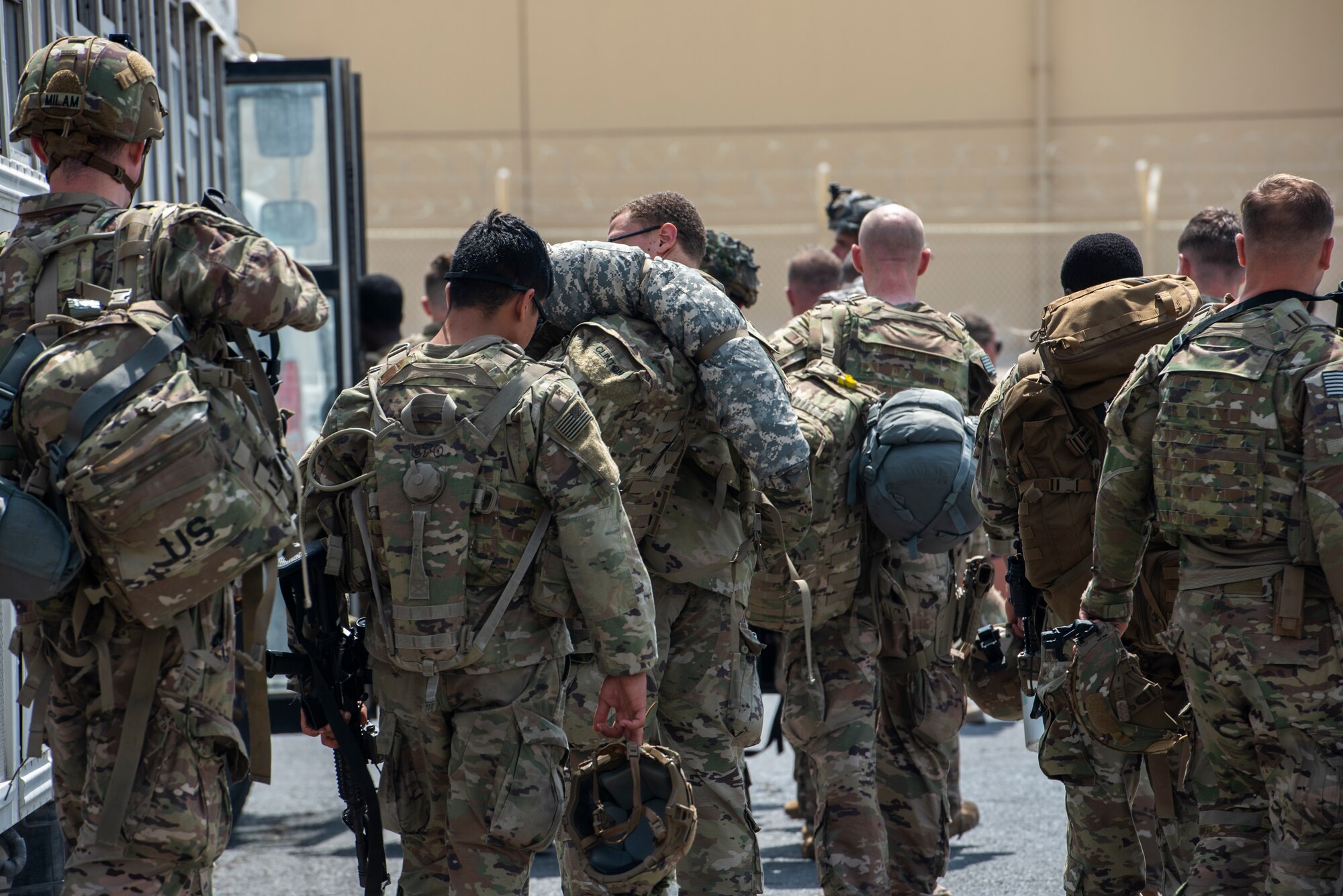 Service members in the CENTCOM area of responsibility prepare to board a bus prior to deploying to Afghanistan Aug. 19, 2021, at Al Udeid Air Base, Qatar.