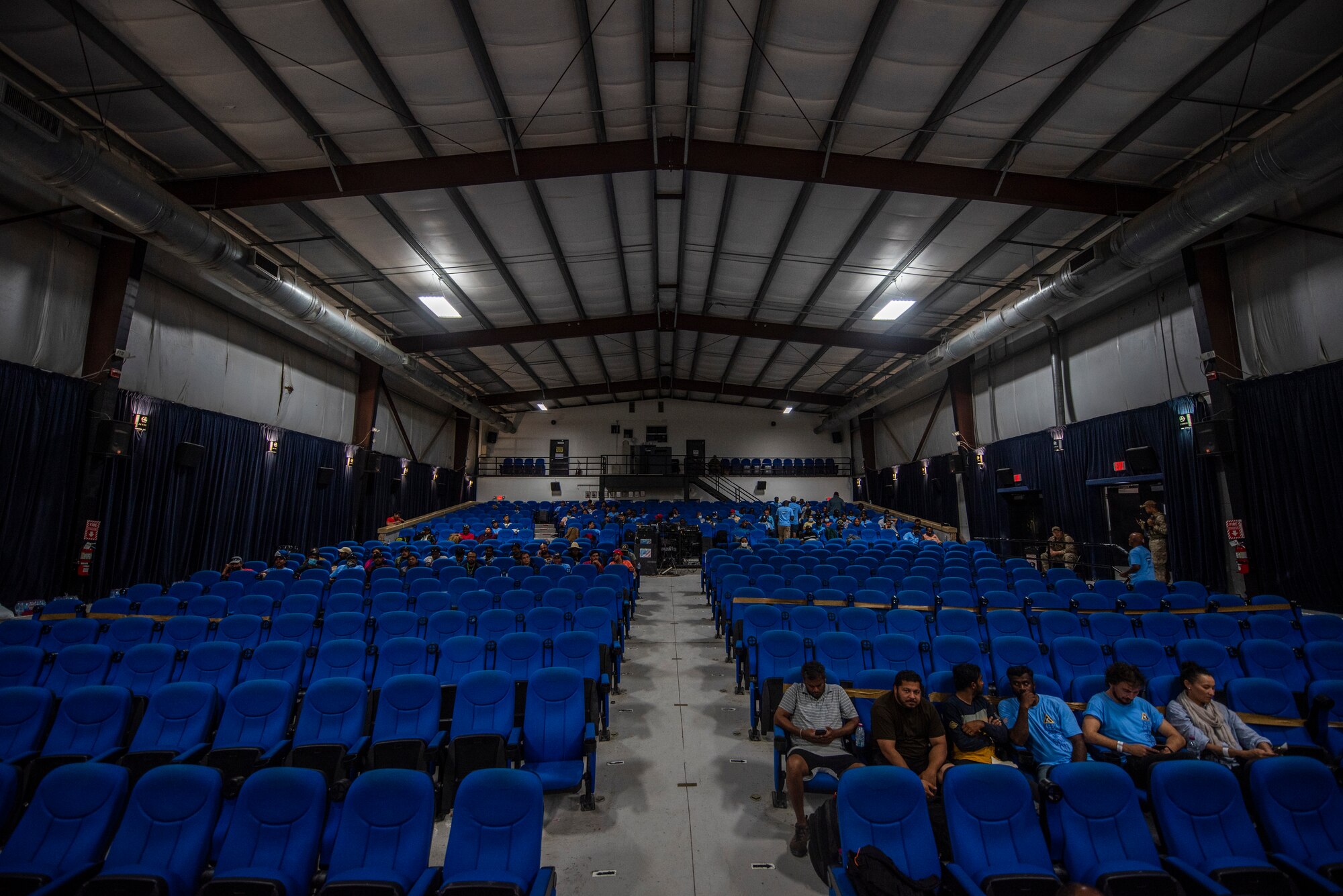 Afghanistan evacuees wait to process at a camp theatre in the CENTCOM region, Aug. 20, 2021.