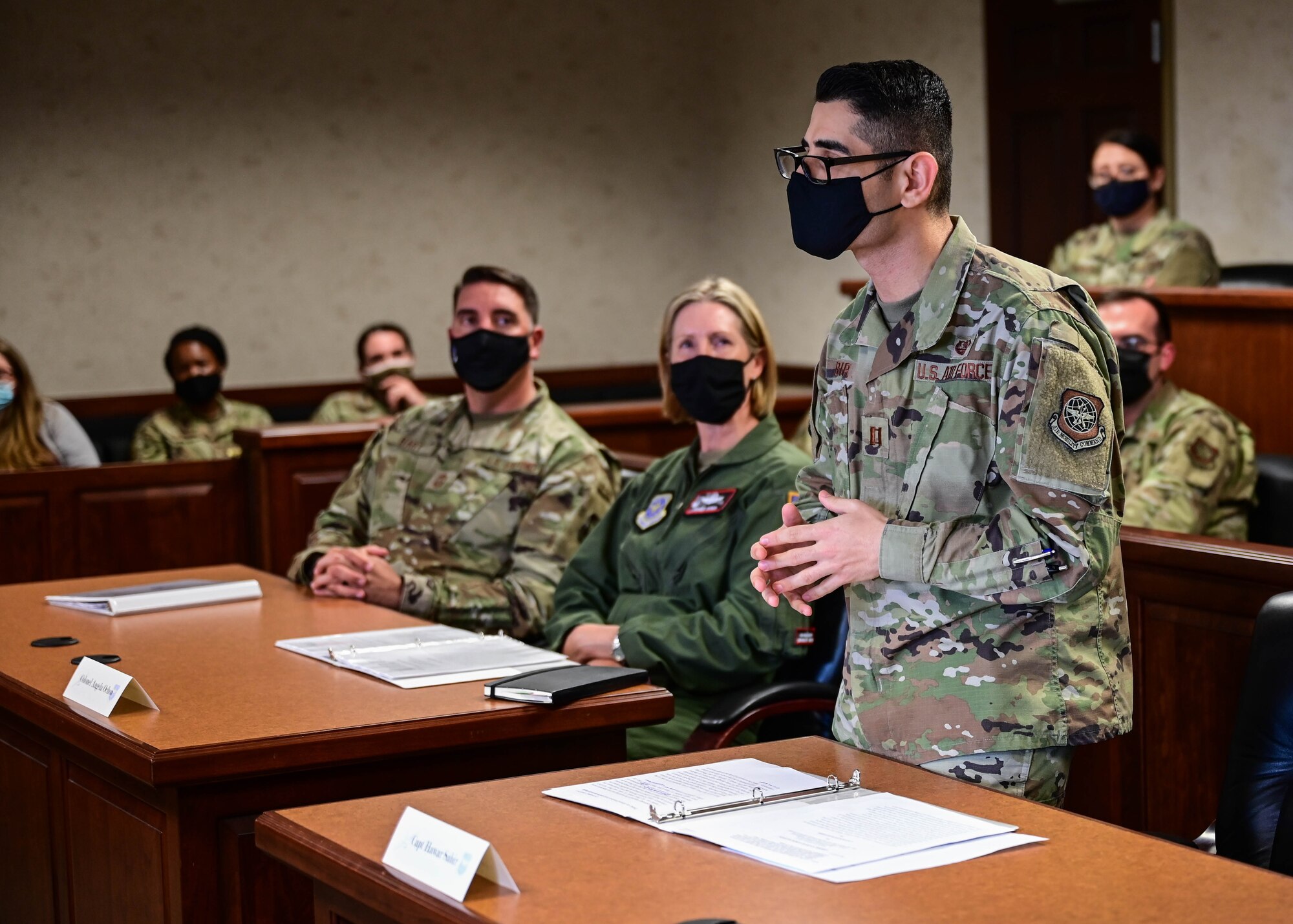A man speaks to an audience in a court room