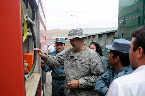 U.S. Army Spc. Travis Hale, a combat engineer with Headquarters and Headquarters Company, 86th Infantry Brigade Combat Team (Mountain), Task Force Wolverine, inspects Afghan National Police's firefighting equipment at the Operations Command Center Aug. 5, 2010, in Bamyan, Afghanistan.