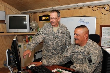 Chief Warrant Officer 4 Kent Samson, left, and Master Sgt. Michael Sanchez, both members of the support operations section, 186th Brigade Support Battalion, Vermont Army National Guard, work together to complete an order form Aug. 9, 2010, in their SPO shop at Camp Phoenix in Kabul, Afghanistan. Samson and Sanchez are two of 24 soldiers who work in the SPO section that order supplies for soldiers around the Kabul Base Cluster.