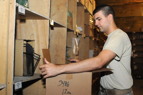 Sgt. Kris Maxham, a supply sergeant with Alpha Company of the 186th Brigade Support Battalion, Vermont Army National Guard, cuts open a box of binders to restock the supply at the Self Service Supply Center Aug. 10, 2010, at Camp Phoenix in Kabul, Afghanistan. The SSSC is one of three warehouses Alpha Company manages.