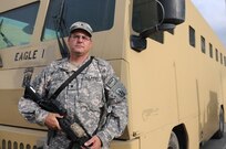 Spc. Steven Griggs, a truck driver for Alpha Company, 186th Brigade Support Battalion, Vermont Army National Guard, poses for a picture in front of his Rhino Runner Aug. 10, 2010, at Camp Phoenix in Kabul, Afghanistan. Griggs and other members from Alpha Company's truck platoon move service members and civilians with the Rhino Runners safely to destinations throughout Kabul.