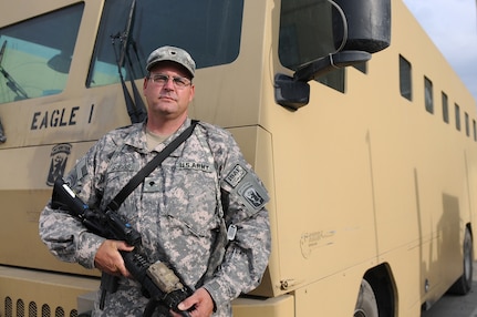 Spc. Steven Griggs, a truck driver for Alpha Company, 186th Brigade Support Battalion, Vermont Army National Guard, poses for a picture in front of his Rhino Runner Aug. 10, 2010, at Camp Phoenix in Kabul, Afghanistan. Griggs and other members from Alpha Company's truck platoon move service members and civilians with the Rhino Runners safely to destinations throughout Kabul.