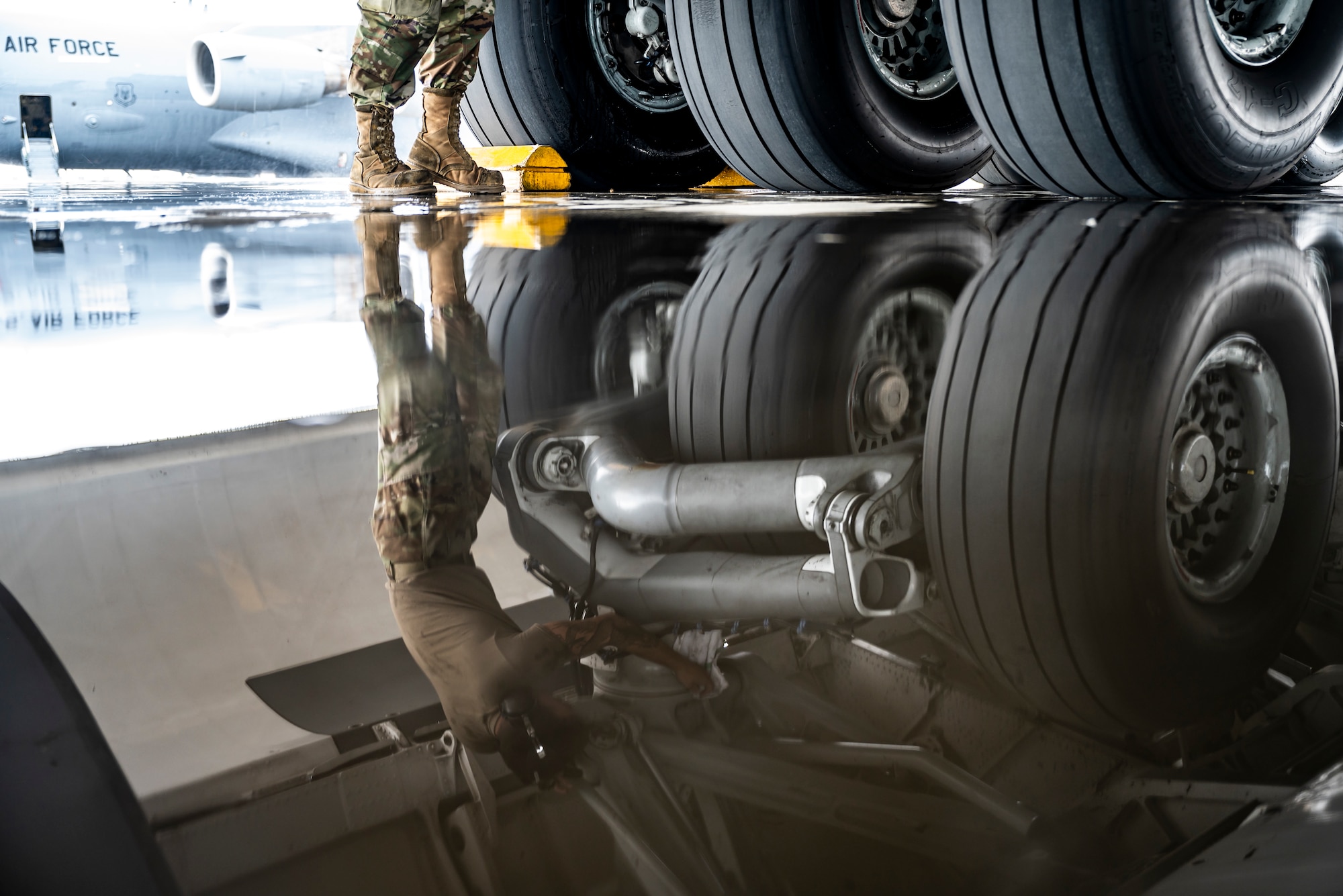 Senior Airman Clayton Roppa, 911th Aircraft Maintenance Squadron crew chief, wipes down the landing gear of a C-17 Globemaster III at the Pittsburgh International Airport Air Reserve Station, Pennsylvania, Aug. 16, 2021. Airmen routinely wipe down a variety of parts of the aircraft to help prevent corrosion.