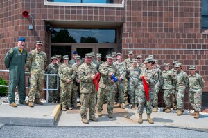 Lt. Col. Gregory S. Sell, 911th Aeromedical Evacuation Squadron commander, cuts a ribbon after a lengthy renovation at the Pittsburgh International Airport Air Reserve Station, Pennsylvania, Aug. 6, 2021. Renovations have been completed on the former 911th Avionics Flight building and will soon be staffed by the 911th AES.