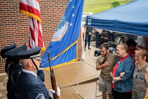 Family members of fallen Airman, Staff Sgt. Dylan Elchin, stand during the singing of the National Anthem and presenting of the Colors by the 911th Airlift Wing Honor Guard during a dedication ceremony renaming the post office in Hookstown, Pennsylvania, Aug. 16, 2021. The post office was renamed after Staff Sgt. Dylan Elchin who was killed by a roadside bomb in Afghanistan’s Ghazni province in November 2018.