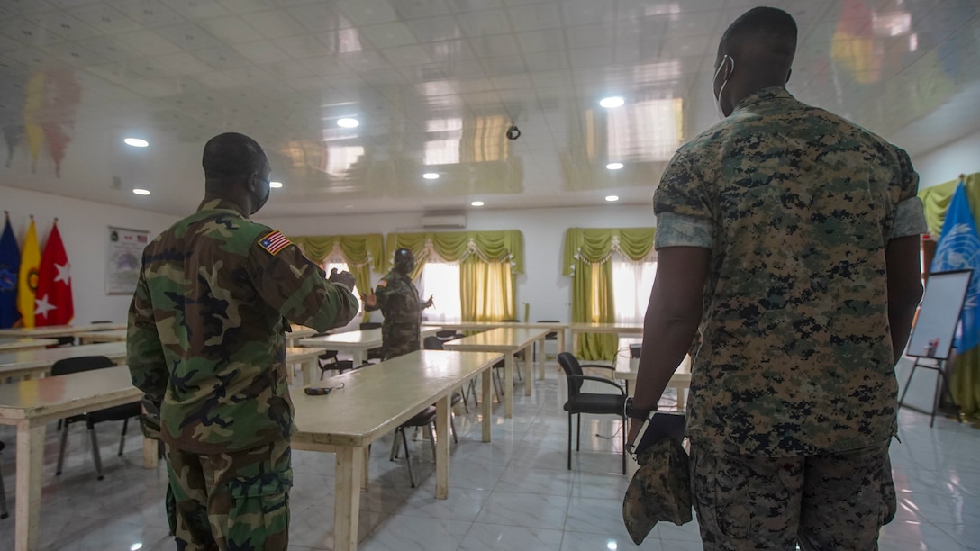 U.S. Marine Corps Staff Sgt. Isaac Pelendo, African Foreign Area Staff Non Commissioned Officer with Marine Forces Europe and Africa (MARFOREUR/AF), discusses the upcoming Women, Peace, and Security (WPS) engagement with members of the Armed Forces of Liberia in Monrovia, Liberia, July 29, 2021. U.S. Marines from MARFOREUR/AF travelled to West Africa to conduct an event in support of the WPS program as part of a national effort to promote the meaningful contributions of women in defense and security sectors around the world. WPS focuses on improving effectiveness of foreign policy and efforts by proactively integrating the needs and perspectives of women, while also empowering them to contribute their talents and energies to international peace, security, and prosperity. (U.S. Marine Corps photo by Sgt. James Bourgeois/Released)