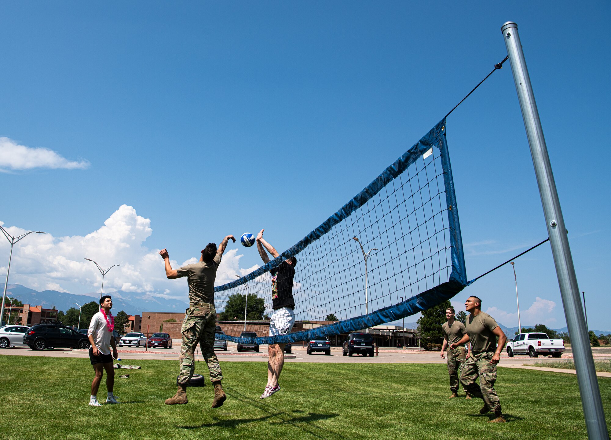 PETERSON SPACE FORCE BASE, Colo. – Airmen and Guardians play volleyball at the Luau on the Lawn at Peterson Space Force Base, Colorado, Aug. 13, 2021. Airmen, Guardians and their families were invited by the Peterson Chapel Team to build comradery and resilience with lunch, games and tips to balance work and home life. (U.S. Space Force photo by Airman 1st Class Joshua Fontenot)