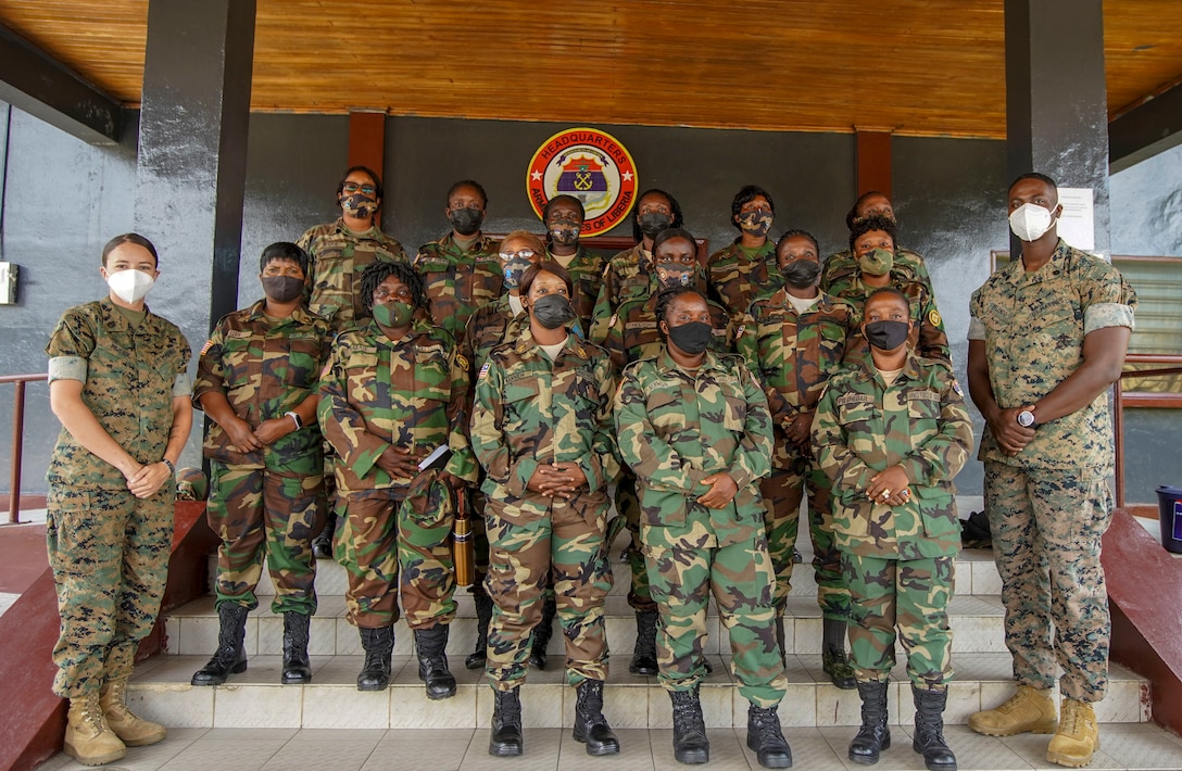 U.S. Marine Corps Staff Sgt. Brytani Musick, left, Communication Strategy and Operations Production Chief, and Staff Sgt. Isaac Pelendo, right, African Foreign Area Staff Non-Commissioned Officer, with Marine Corps Forces Europe and Africa (MARFOREUR/AF), and members of the Armed Forces of Liberia (AFL), pose for a photo in Monrovia, Liberia, July 30, 2021. Marines from MARFOREUR/AF and U.S. Embassy representatives met with 15 AFL women during this first ever WPS engagement between the U.S. military and Liberian military. Women, Peace, and Security is as an integral component in the effort to enhance African partner capability, enabling U.S. security cooperation to better leverage the contributions of both men and women. (U.S. Marine Corps photo by Sgt. James Bourgeois)