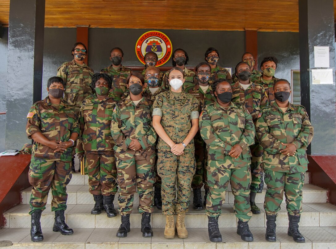 U.S. Marine Corps Staff Sgt. Brytani Musick, Communication Strategy and Operations Production Chief with Marine Corps Forces Europe and Africa (MARFOREUR/AF), and members of the Armed Forces of Liberia, pose for a photo in Monrovia, Liberia, July 30, 2021. Marines from MARFOREUR/AF and U.S. Embassy representatives met with 15 AFL women during this first ever WPS engagement between the U.S. military and Liberian military. Women, Peace, Security is as an integral component in the effort to enhance African partner capability, enabling U.S. security cooperation to better leverage the contributions of both men and women. (U.S. Marine Corps photo by Sgt. James Bourgeois)