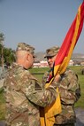 Col. Shawn M. Fuellenbach, the incoming commander of the 65th Field Artillery Brigade passes the organizational colors to Maj. Gen. Michael Turley, the adjutant general, Utah National Guard, during a change-of-command ceremony Aug. 8, 2021, at Camp Williams, Utah.