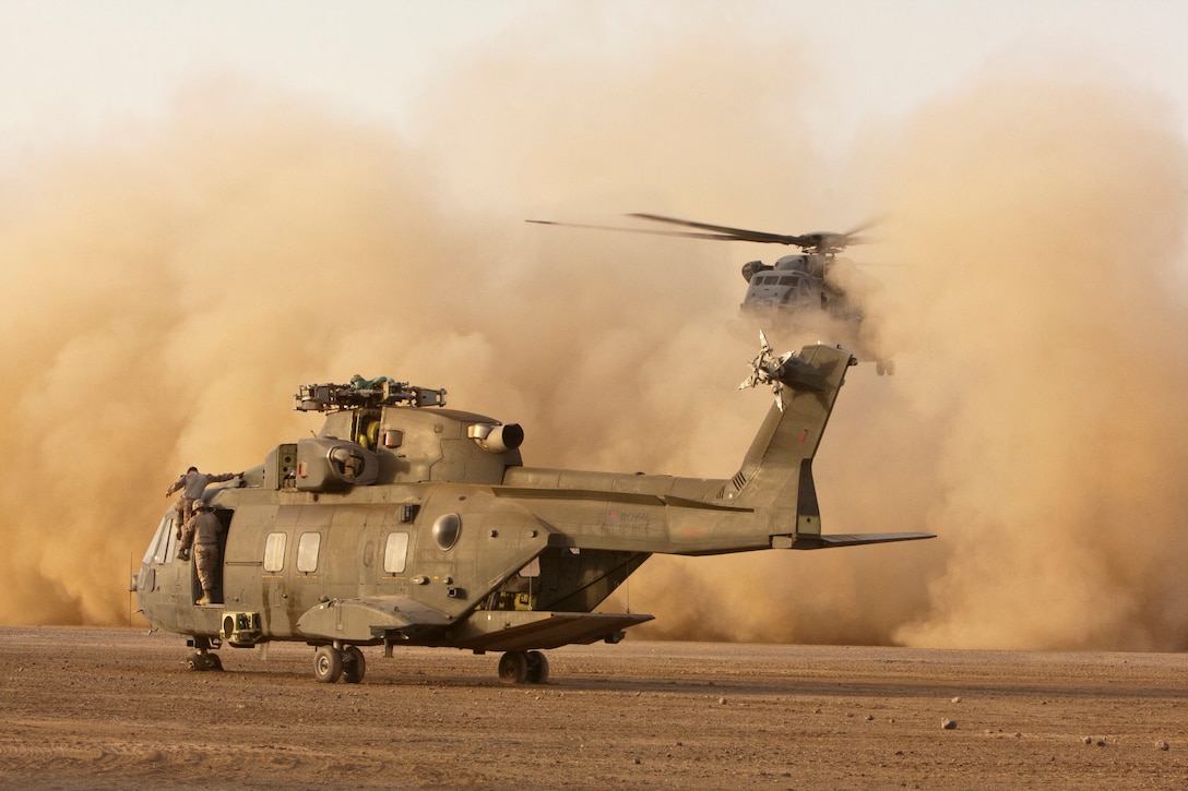 A U.S. Marine Corps CH-53E Super Stallion helicopter, Marine Heavy Helicopter Squadron 464 (HMH-464), takes flight to recover a British Merlin HC3 helicopter, during a Tactical Recovery of Aircraft and Personnel (TRAP) mission, undisclosed location, Helmand Province, Afghanistan, September 15, 2011. HMH-464 performs TRAP missions in order to retrieve U.S. and U.K. Armed Forces equipment and conduct investigations in support of International Security Assistance Force. (U.S. Marine Corps photo by Lance Cpl. Robert R. Carrasco/Released).