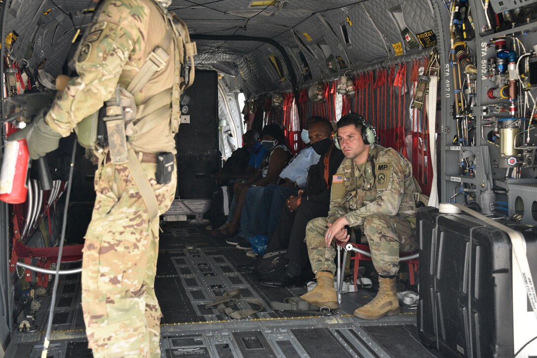 A U.S. Army CH-47 Chinook Helicopter crew transfers doctors from non-impacted areas of Haiti to assist and treat injured Haitian citizens in Port-au-Prince, Haiti, Aug. 23, 2021.