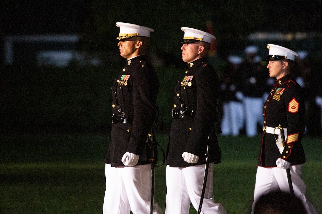 Marines with the parade staff march down Center Walk during the Friday Evening Parade at Marine Barracks Washington, Aug. 20, 2021. The guest of honor for the evening was Mr. Robert J. Conte III, Chief of the Metropolitan Police Department, and the hosting official was Lt. Gen. David A. Ottignon, Deputy Commandant for Manpower and Reserve. (U.S. Marine Corps photo by Lance Cpl. Tanner D. Lambert)