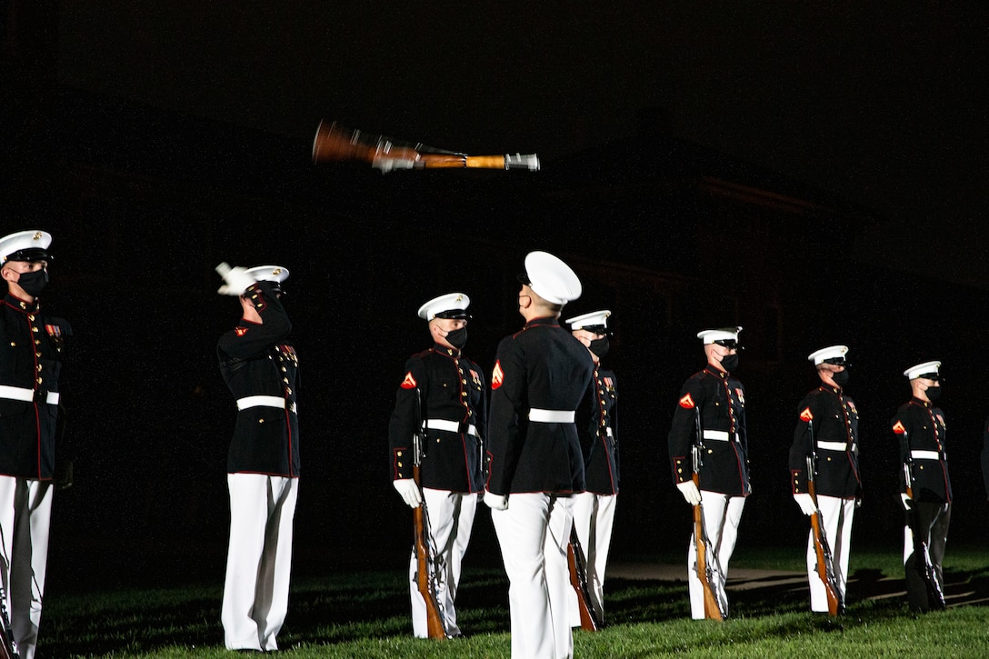 Marines with the Silent Drill Platoon execute their “rifle inspection” sequence during the Friday Evening Parade at Marine Barracks Washington, Aug. 20, 2021. The guest of honor for the evening was Mr. Robert J. Conte III, Chief of the Metropolitan Police Department, and the hosting official was Lt. Gen. David A. Ottignon, Deputy Commandant for Manpower and Reserve. (U.S. Marine Corps photo by Lance Cpl. Tanner D. Lambert)