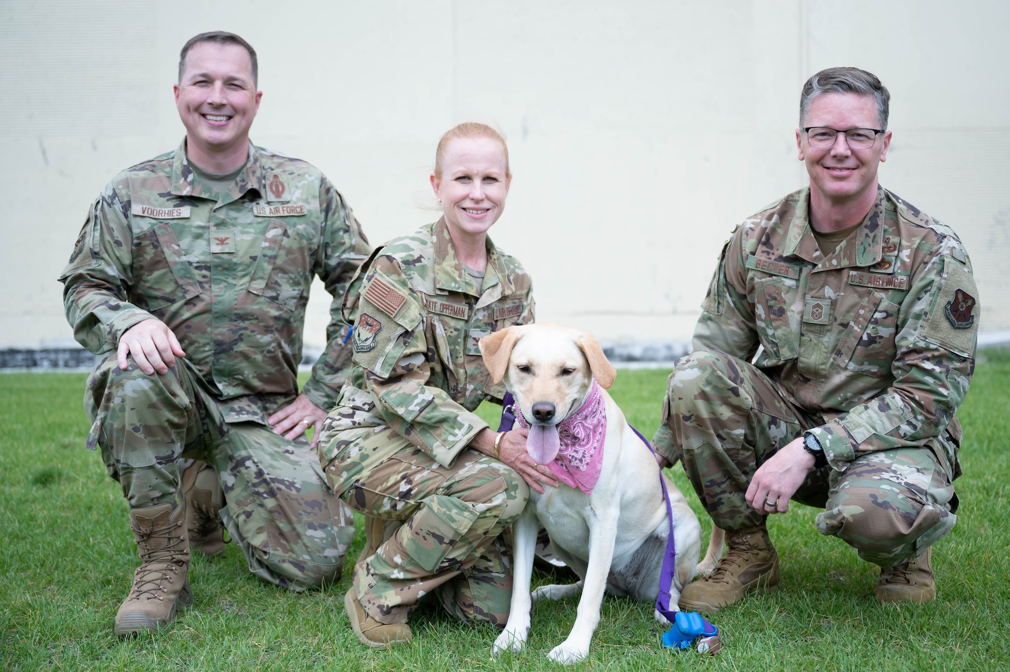 Col. Anita Feugate Opperman, center, 341st Missile Wing commander, Col. Daniel Voorhies, left, 341st MW vice commander, Chief Master Sgt. Michael Becker, right, 341st MW command chief, and Aspen, front, 341st MW top dog, pose for a photo Aug. 10, 2021, at Malmstrom Air Force Base, Mont.