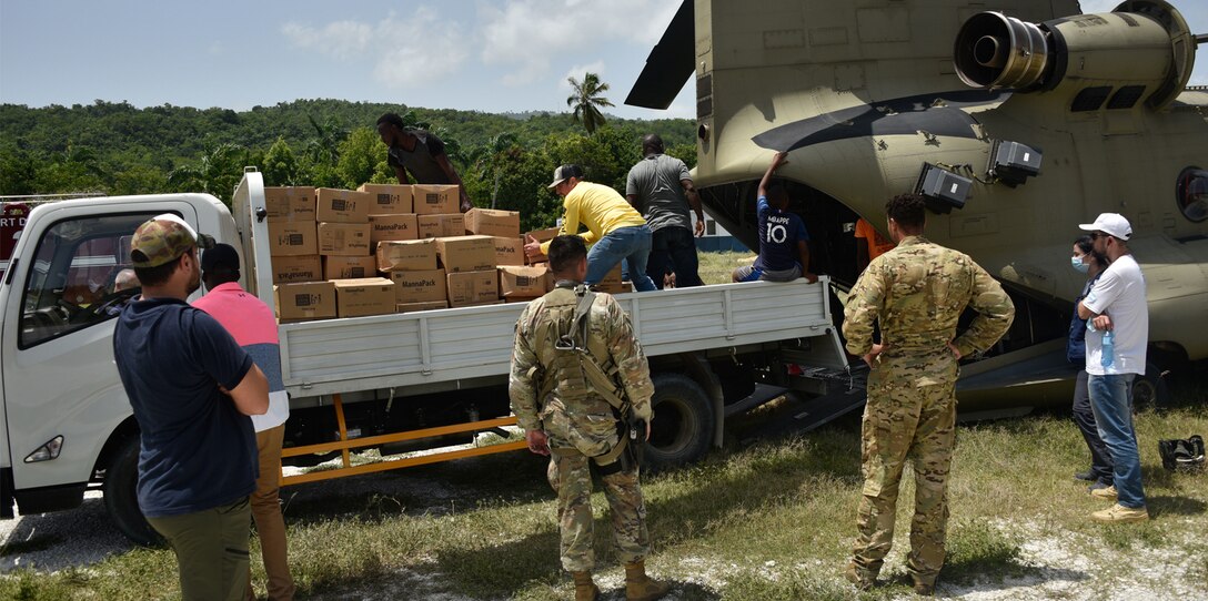 A U.S. Army CH-47 Chinook Helicopter crew and partner agencies deliver emergency medical equipment and food to Haitian citizens in impacted areas of Haiti, Aug. 23, 2021.