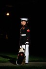 Lance Cpl. Rebekah Macias, mascot handler, Marine Barracks Washington, stands on Center Walk with the official Marine Corps mascot, Lance Cpl. Chesty XV, during the Friday Evening Parade MBW, Aug. 20, 2021.