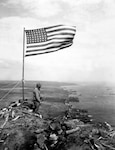 From the crest of Mount Suribachi, the Stars and Stripes wave in triumph over Iwo Jima after U.S. Marines had fought their way inch by inch up its steep lava-encrusted slopes.  Ca.  February 1945.  PhoM3c. John Papsun.  (Coast Guard)
NARA FILE #:  026-G-4140
WAR & CONFLICT BOOK #:  1222