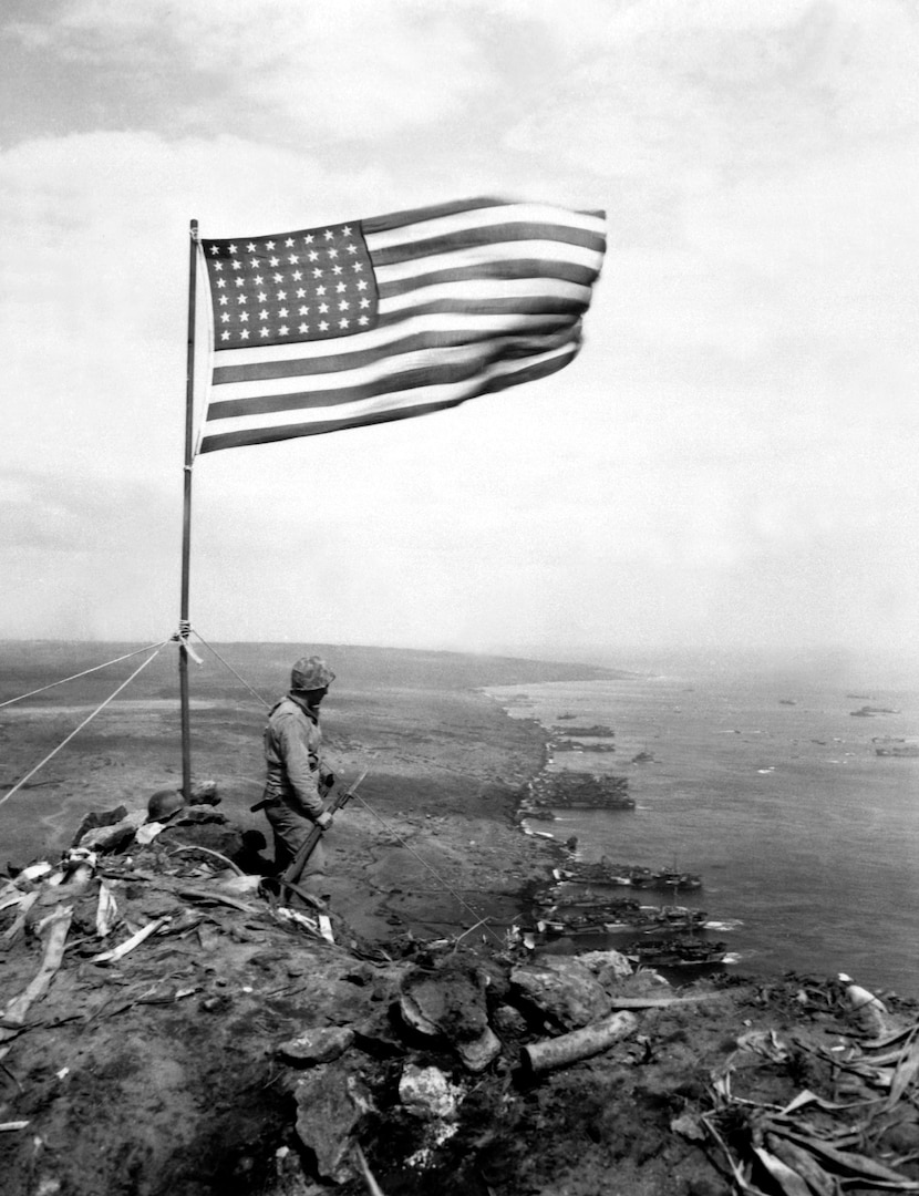 From the crest of Mount Suribachi, the Stars and Stripes wave in triumph over Iwo Jima after U.S. Marines had fought their way inch by inch up its steep lava-encrusted slopes.  Ca.  February 1945.  PhoM3c. John Papsun.  (Coast Guard)
NARA FILE #:  026-G-4140
WAR & CONFLICT BOOK #:  1222