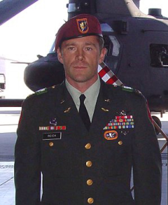 A soldier poses for a photo.