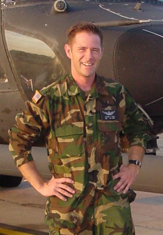 A soldier poses for a photo.