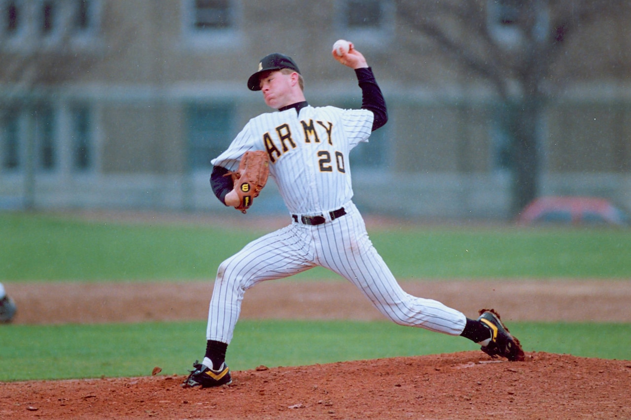 A cadet pitches a baseball.