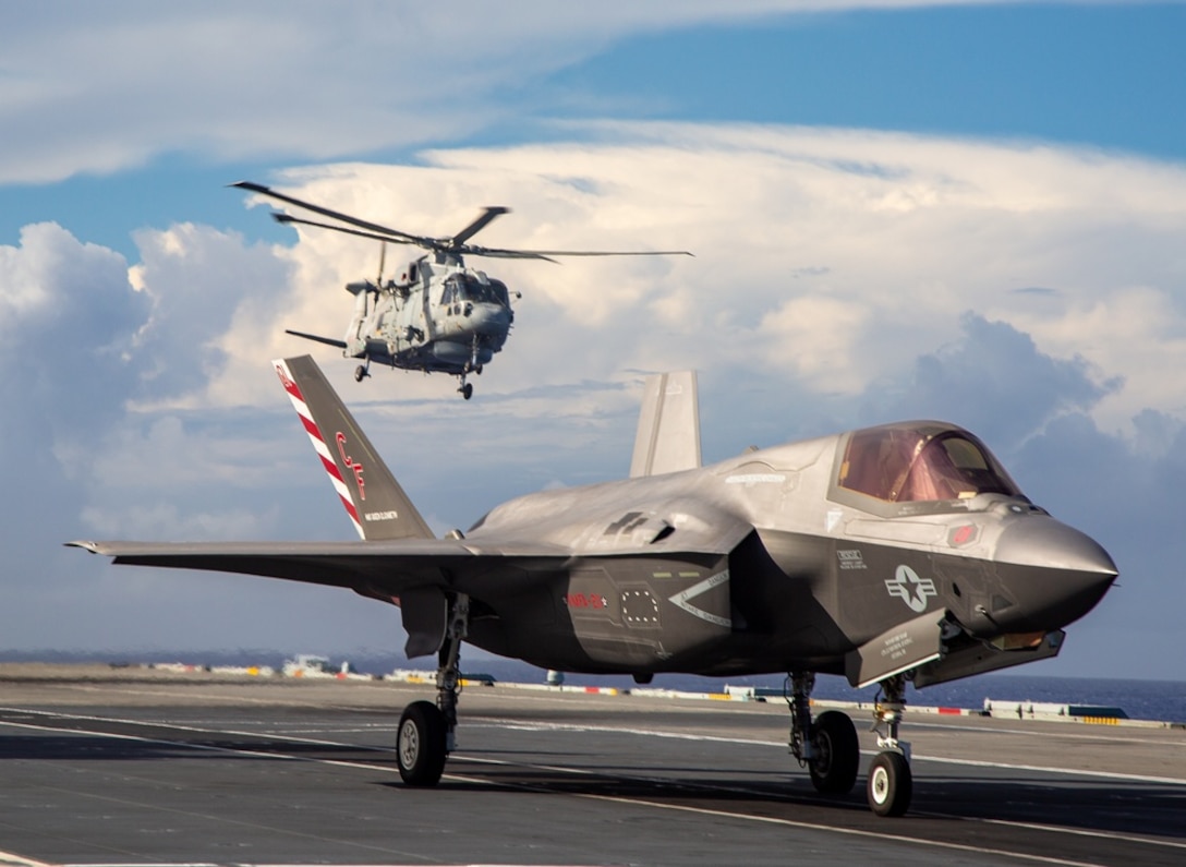 U.S. Marine Corps Maj Brian Kimmins prepares to launch an F-35B from HMS Queen Elizabeth for a historic cross-deck operation with USS America in the Pacific Ocean on August 20, 2021. The operation highlighted the interoperability of the F-35B and the strategic importance of the joint integration between the United Kingdom Carrier Strike Group and the U.S. Navy Amphibious Ready Group / Marine Expeditionary Unit. This mission was the first time in modern history the United States has cross-decked aircraft for a mission utilizing a foreign aircraft carrier, demonstrating naval partnerships in action.