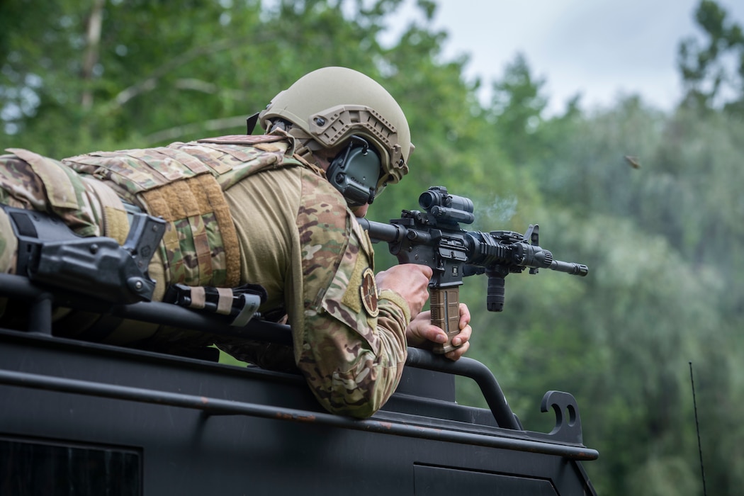 U.S. Air Force Staff Sgt. Adam Roach, 103rd Security Forces Squadron, fires an M4 carbine from the roof of a SWAT vehicle during the Connecticut SWAT Challenge in East Granby, Connecticut, Aug. 18, 2021. The competition brings together tactical operators from across the nation to train SWAT weapons tactics, movements, and physical fitness. (U.S. Air National Guard photo by Tech. Sgt. Steven Tucker)