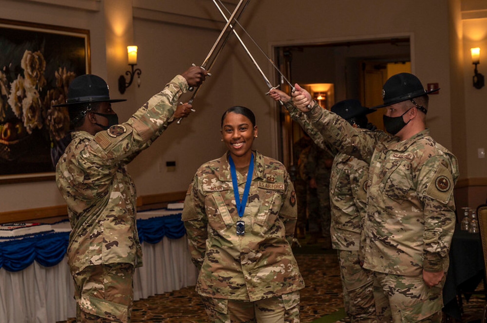 Female NCO passes under saber cordon