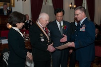 U.S. Air Force Maj. Gen. Steven Cray congratulates Fred Newhall during an awards ceremony being held at the state house in Montpelier, Vt., Nov. 12, 2013. Newhall was one of 28 Vermonters to receive an award from the Republic of Korea, for his service during the Korean War. (U.S. Air National Guard photo by Staff Sgt. Sarah Mattison)