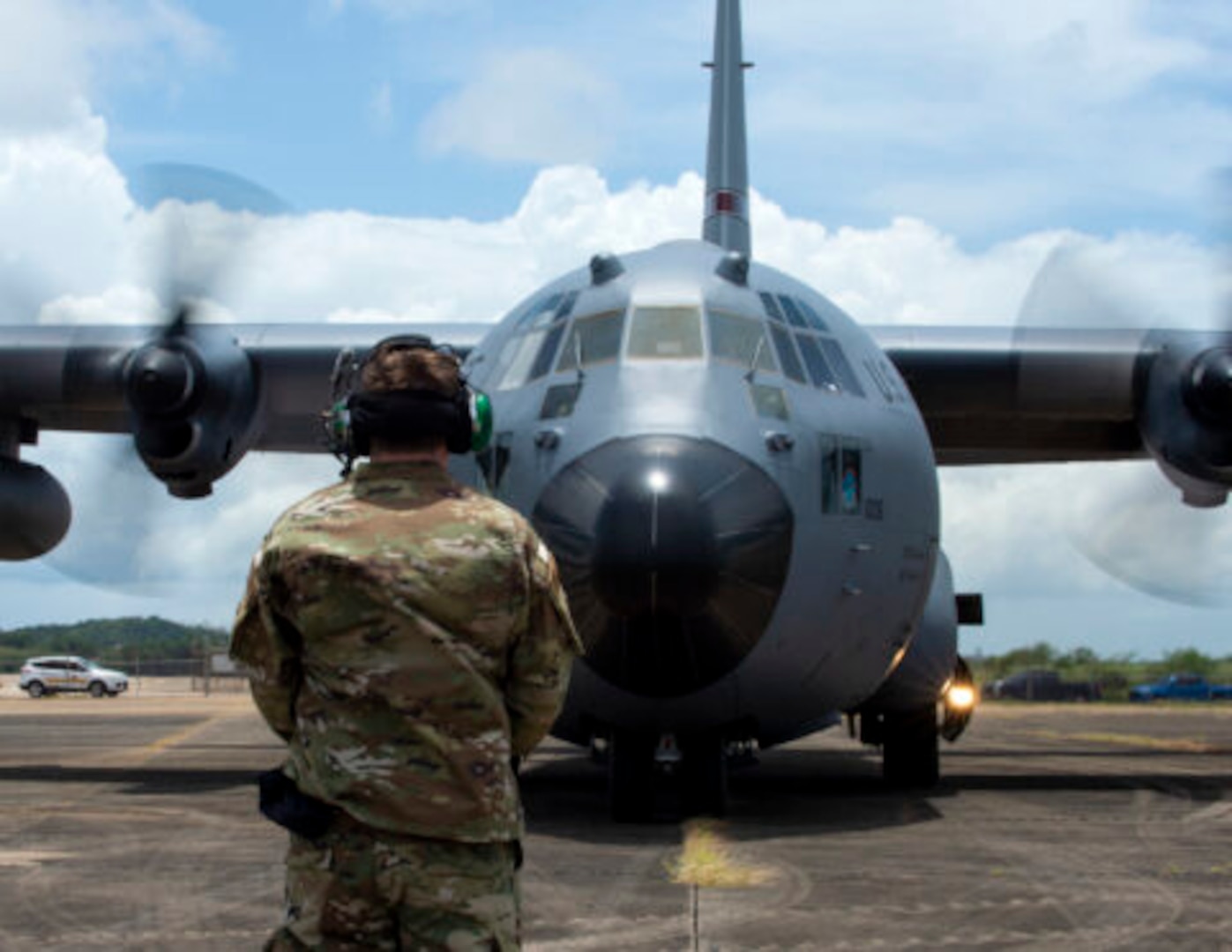 An Airman with the 123rd Contingency Response Group, Kentucky Air National Guard, waits to marshal a C-130 Hercules from the 133rd Airlift Wing in Aguadilla, Puerto Rico, Aug. 18, 2021. The Airman was part of a training exercise to respond to natural disasters and set up airbase operations.