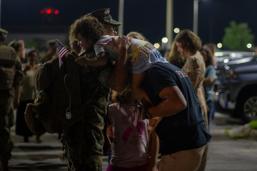 U.S. Marine Corps Lance Cpl. Antonio Perez, a transmissions system operator with 2d Battalion, 2d Marine Regiment (2/2), 2d Marine Division, embraces his family at Camp Lejeune, N.C., Aug. 20, 2021. 2/2 returned to Camp Lejeune after spending six months in Okinawa participating in a Unit Deployment Program. (U.S. Marine Corps photo by Pfc. Sarah Pysher)