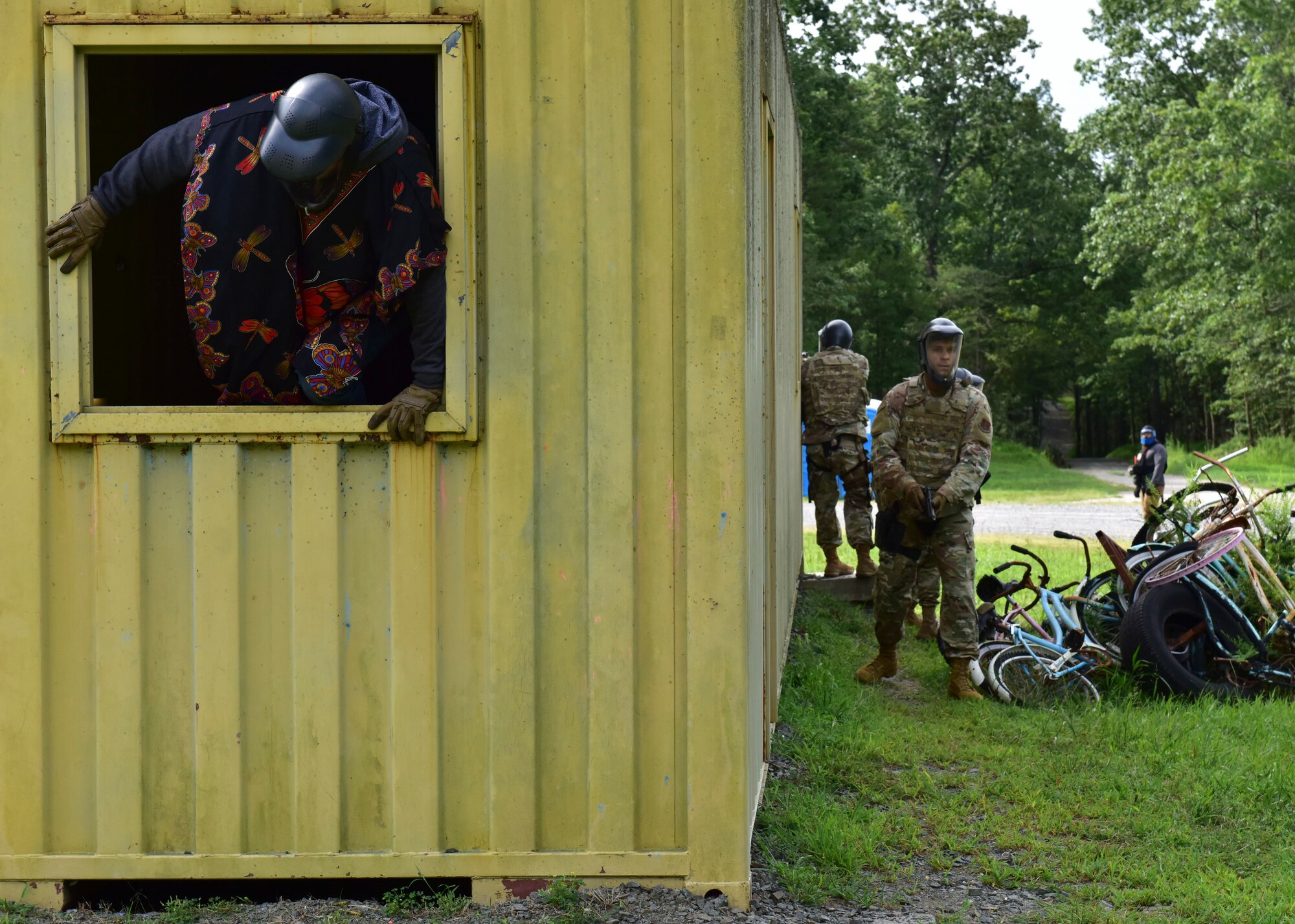 A 421st Combat Training Squadron instructor acting as opposition forces, climbs out of a window during a hostile scenario during the Fieldcraft Judge Advocate Course, Aug. 19, 2021, on Joint Base McGuire-Dix-Lakehurst, New Jersey. The 421st CTS is responsible for developing and conducting pre-deployment field craft skills training for the hostile and uncertain environments, air advisor training, contingency response group formal training and air base opening readiness. (U.S. Air Force photo by Staff Sgt. Jake Carter)