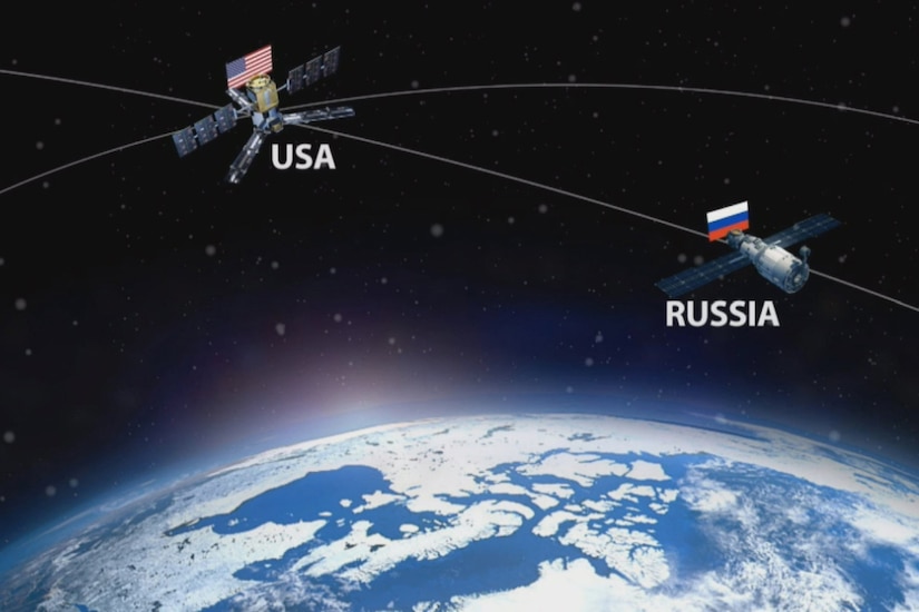A graphic showing a U.S. and Russian satellite depicts them just above the curvature of the Earth.
