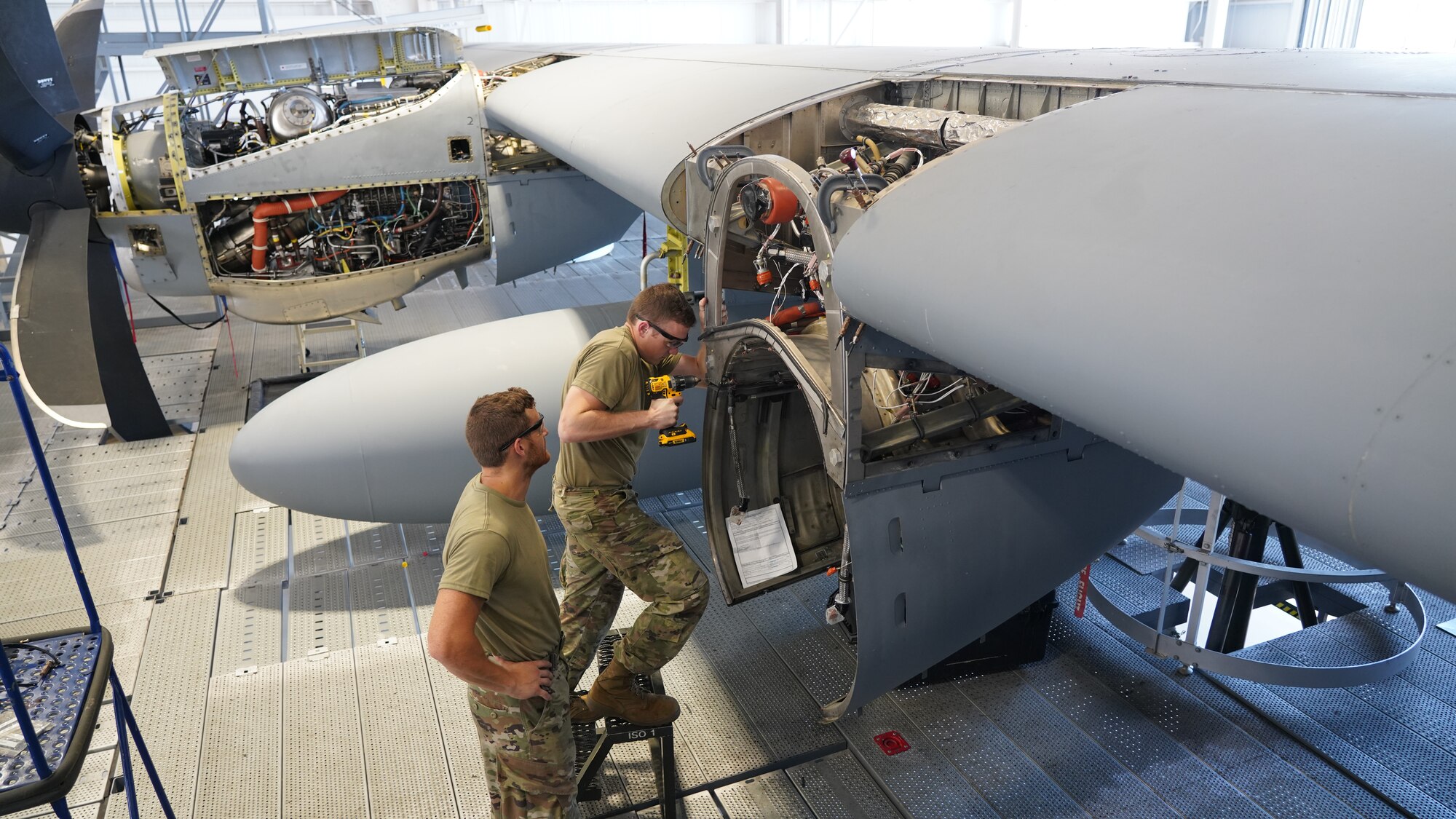 Tech. Sgt. Kevin Lancaster supervises Staff Sgt. William Parker, 403rd Fabrication Flight aircraft structure mechanic, drills a hole in the engine bulkhead of a WC-130J Super Hercules aircraft at Keesler Air Force Base, Miss., Aug. 24, 2021. The flight is responsible for aircraft structural maintenance to include painting and sanding of aircraft parts. The 403rd Wing’s fleet consists of 10 WC-130J and 10 C-130J aircraft which are flown by the 53rd Weather Reconnaissance Squadron and 815th Airlift Squadron, respectively. (U.S. Air Force photo by 2nd Lt. Christopher Carranza)