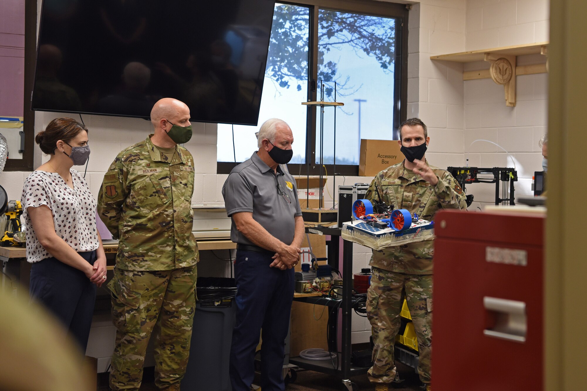 U.S. Air Force Staff Sgt. Jonathan Bahr, 312th Training Squadron Special Instruments Training course instructor speaks with San Angelo community leaders and Goodfellow leadership on Goodfellow Air Force Base, Texas, Aug. 24, 2021. Bahr explained how the hovercraft was designed and build entirely by student innovation, initiative, and with skills and concepts learned from their course. (U.S. Air Force photo by Senior Airman Abbey Rieves)