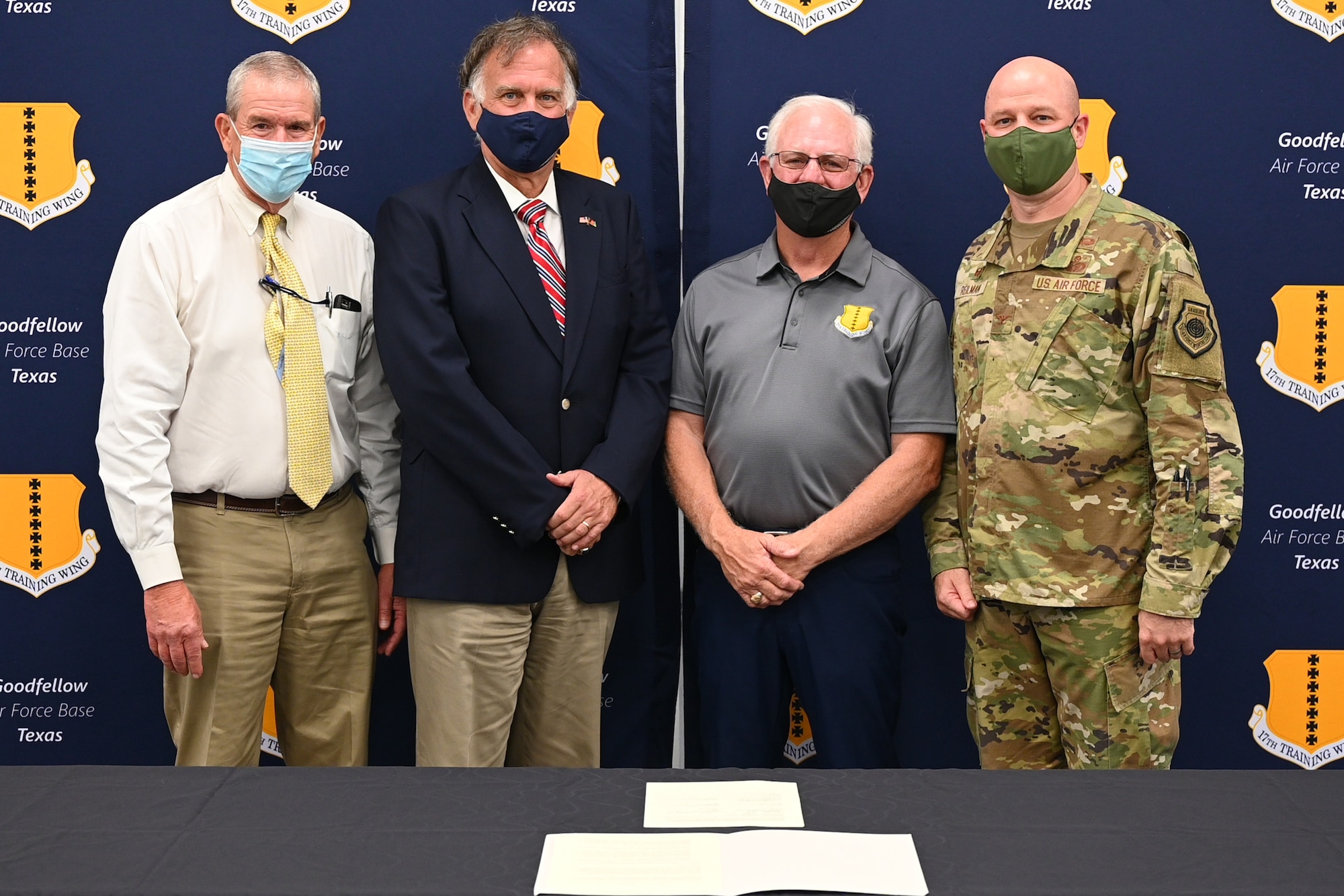 U.S. Air Force Col. Matthew Reilman, 17th Training Wing commander, and San Angelo civic leaders pose in front of a new partnership charter at the Cressman Dining Facility, on Goodfellow Air Force Base, Texas, Aug. 24, 2021. The partnership charter recommitted Goodfellow and San Angelo’s shared goals. (U.S. Air Force photo by Senior Airman Ethan Sherwood)