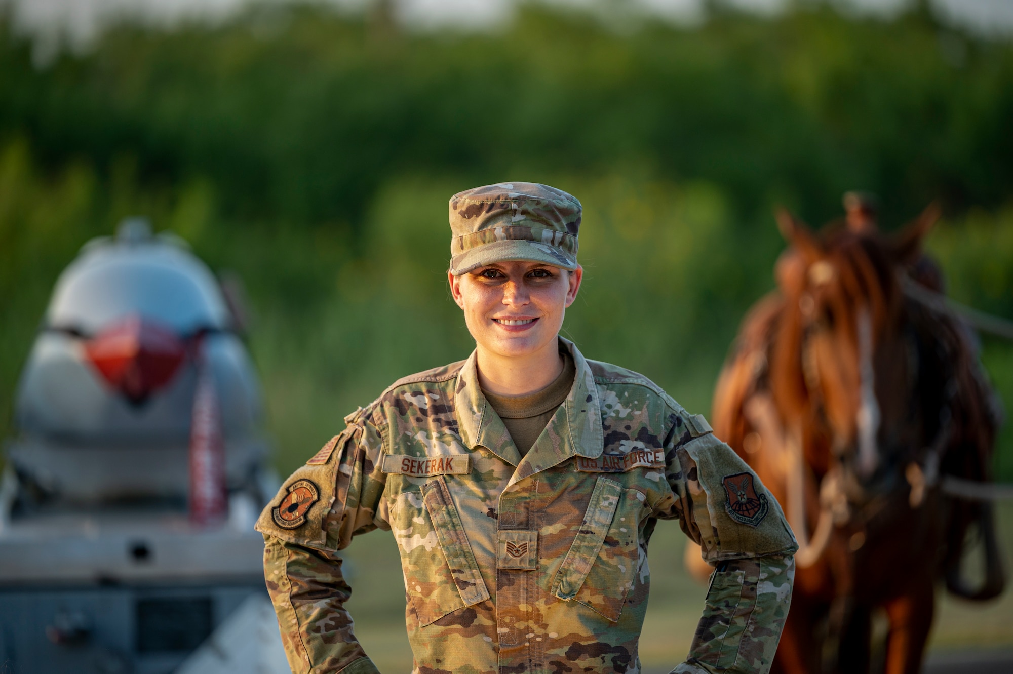 Staff Sgt. Melissa Sekerak, 7th Munitions Squadron stockpile management supervisor, poses for a photo with her horse, Malibu, and an inert munition at Dyess Air Force Base, Texas, Aug. 5, 2021.